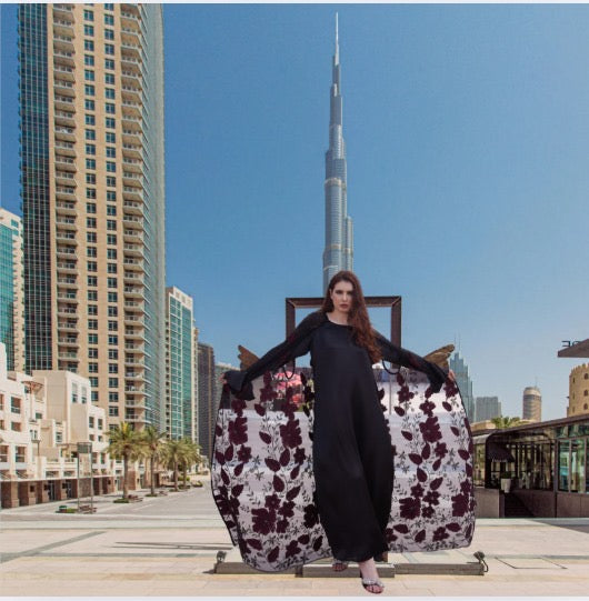 Luxurious silk maxi paired with feather-pattern cape