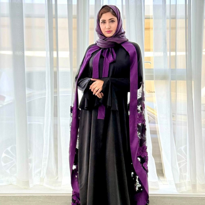Luxurious silk maxi paired with feather-pattern cape