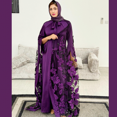 Luxurious silk maxi paired with feather-pattern cape