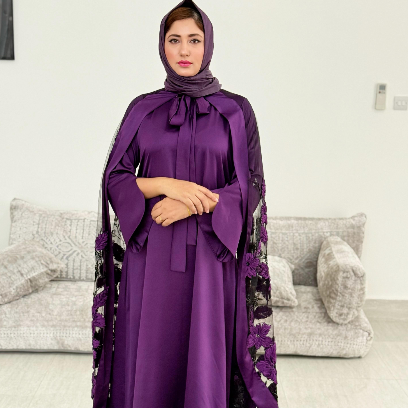 Luxurious silk maxi paired with feather-pattern cape