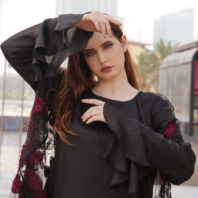 Luxurious silk maxi paired with feather-pattern cape