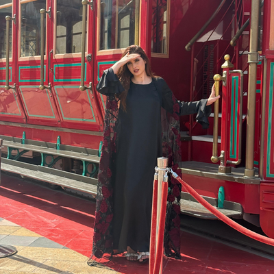 Luxurious silk maxi paired with feather-pattern cape