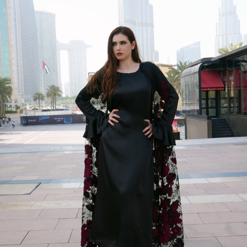 Luxurious silk maxi paired with feather-pattern cape