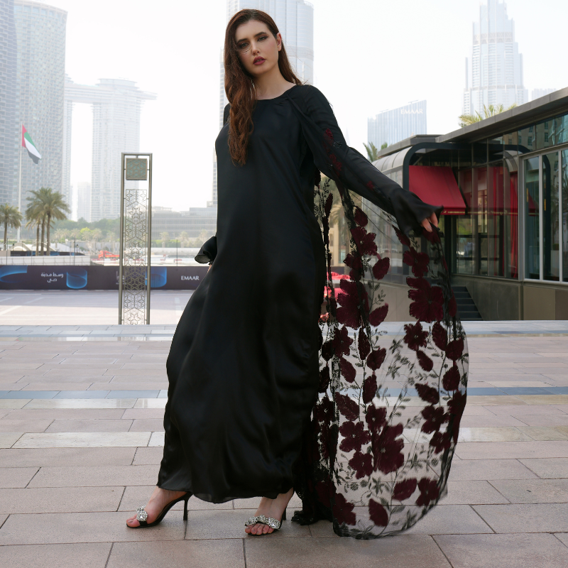 Luxurious silk maxi paired with feather-pattern cape